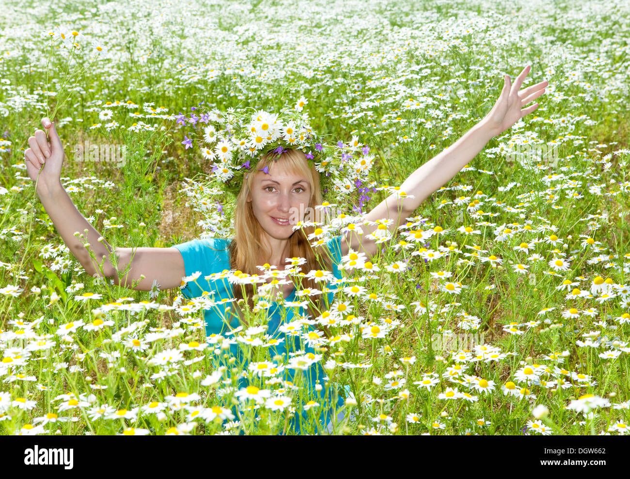 young woman in a wreath from wild flowers Stock Photo