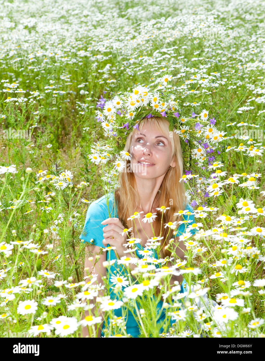 young woman in a wreath from wild flowers Stock Photo
