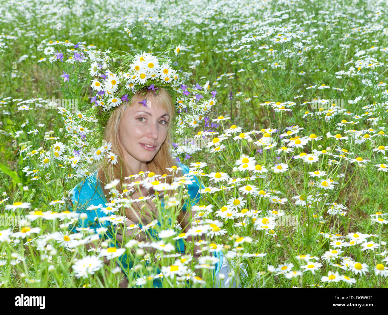 woman in a wreath from wild flowers Stock Photo