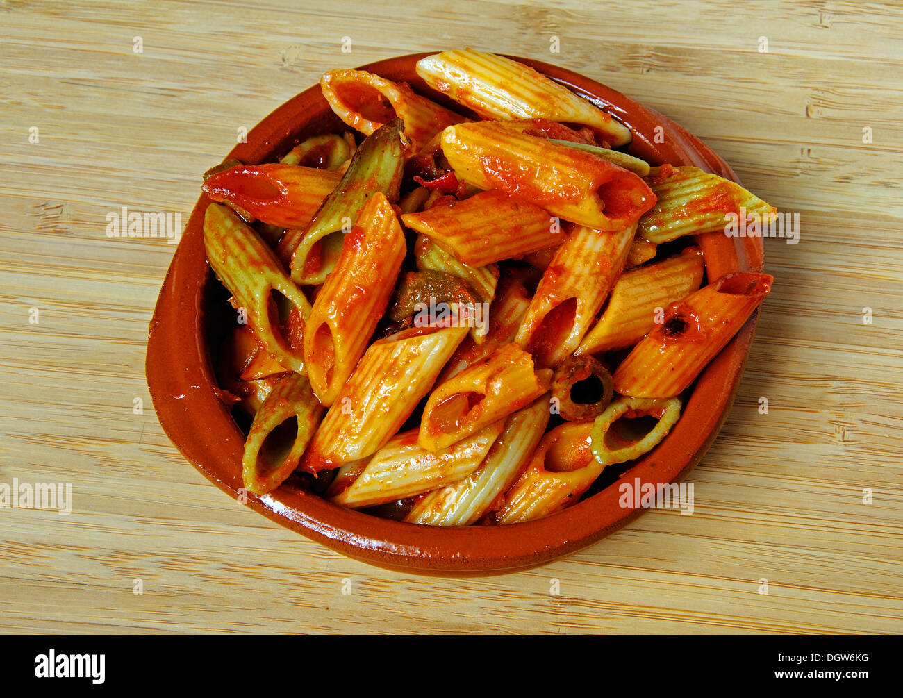 Multicoloured Penne pasta in tomato sauce Stock Photo Alamy