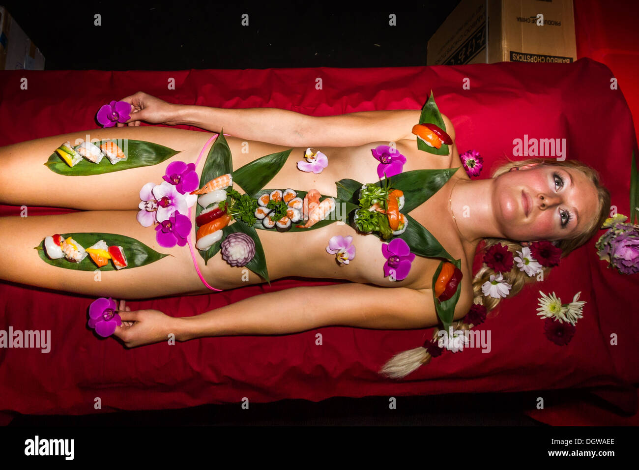 'Nyotaimori' Naked Lady Sushi at Erotica 2013 Show held at Tobacco Dock in east London Stock Photo