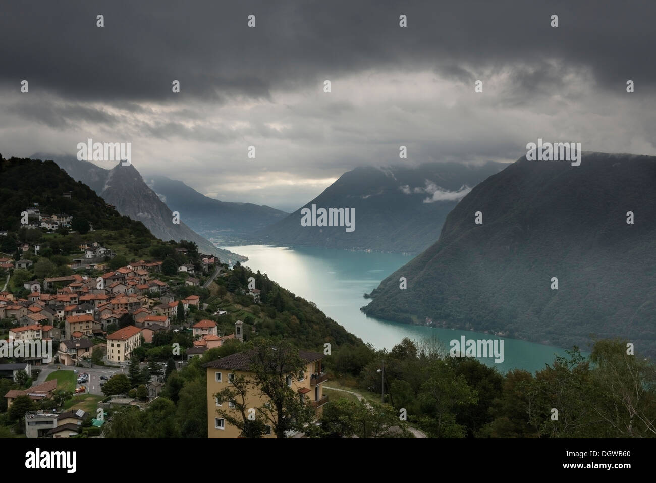 Bré VIllage viewed from Mount Bre, Gulf of Lugano and the Alps. Canton Ticino, Switzerland Stock Photo