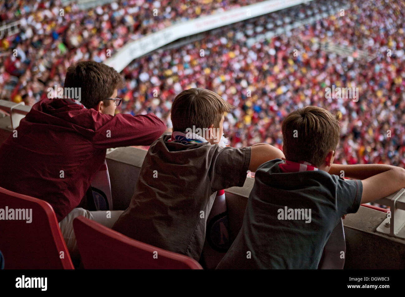 YOUNG BOYS WATCHING FOOTBALL AT ARSENAL football club home ground the EMIRATES STADIUM Stock Photo