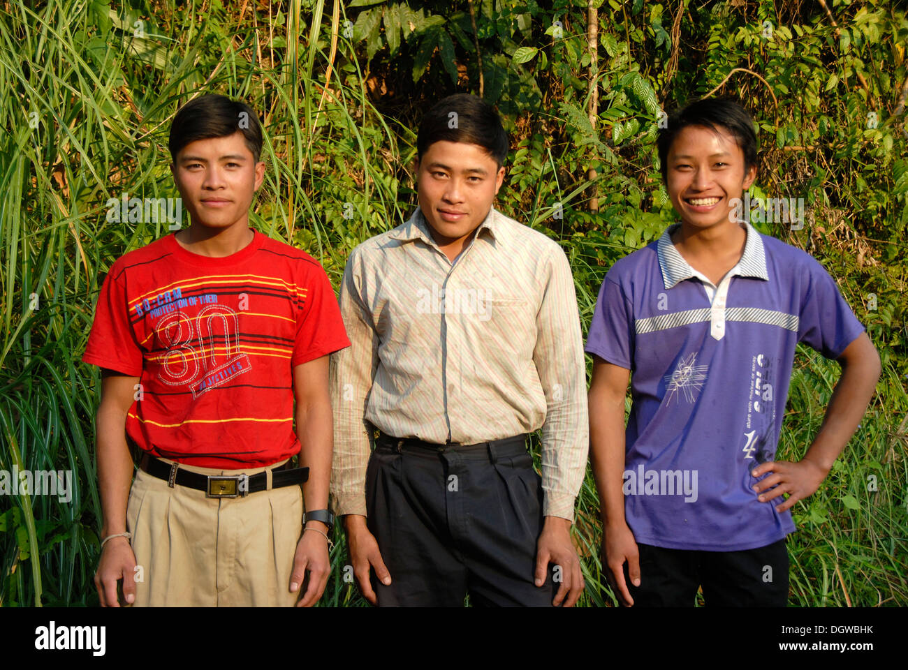 Portrait of three friendly looking young men of the Tai Lue ethnic group in the jungle near Ban Sopkang, Phou Den Din National Stock Photo