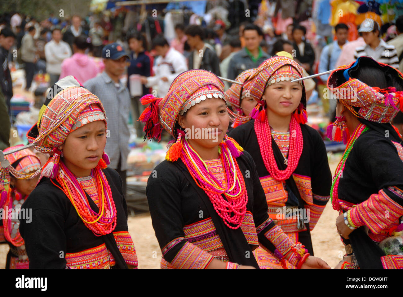 Girls of the Akha Pala ethnic group in colourful traditional dress with pink necklaces and coloured turbans with silver coins Stock Photo