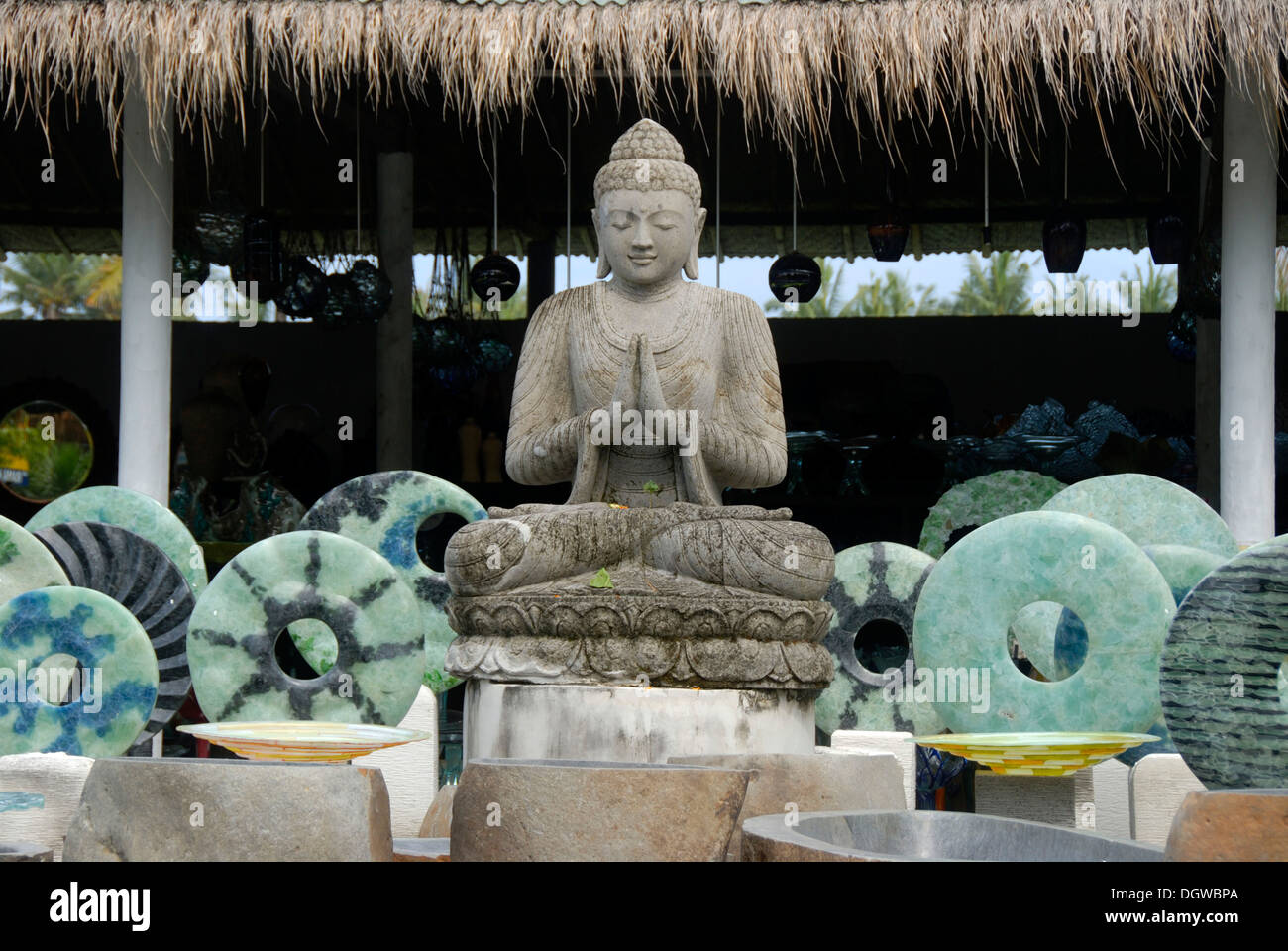 Stone sculptures, souvenirs, Buddha statue in meditation with blue stone rings on sale in shop, near Ubud, Bali, Indonesia Stock Photo