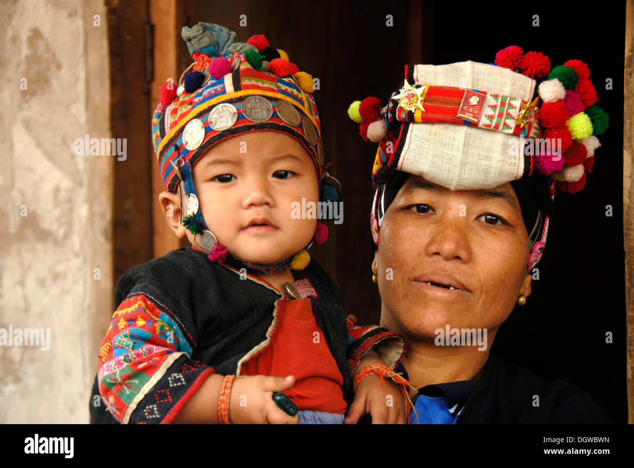 Portrait of a woman of the Phoussang ethnic group wearing traditional costume and colourful pompon hat with silver coins Stock Photo