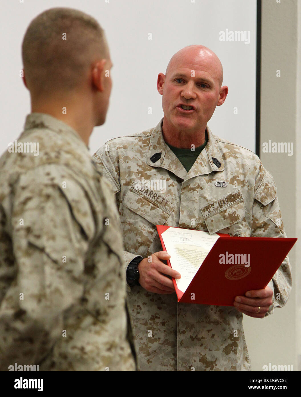 The 35th commandant of the Marine Corps, General James F. Amos, and the 17th sergeant major of the Marine Corps, Sgt. Maj. Micheal P. Barrett, promote Lance Cpl. Wesleigh M. Beckman, ordnance technician with Marine Aviation Logistics Squadron 11 (MALS-11) Stock Photo