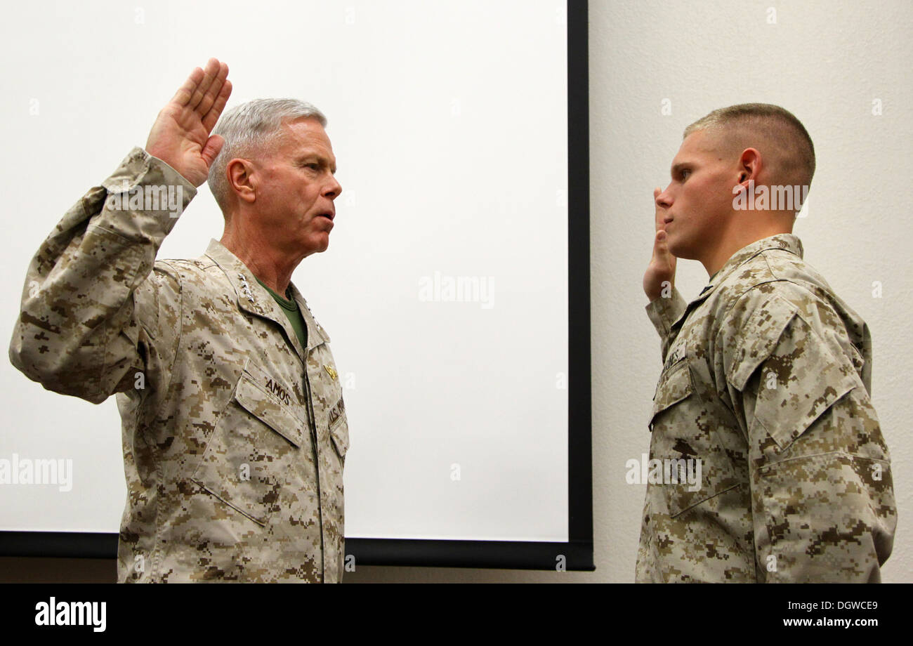 The 35th commandant of the Marine Corps, General James F. Amos, and the 17th sergeant major of the Marine Corps, Sgt. Maj. Micheal P. Barrett, promote Lance Cpl. Wesleigh M. Beckman, ordnance technician with Marine Aviation Logistics Squadron 11 (MALS-11) Stock Photo