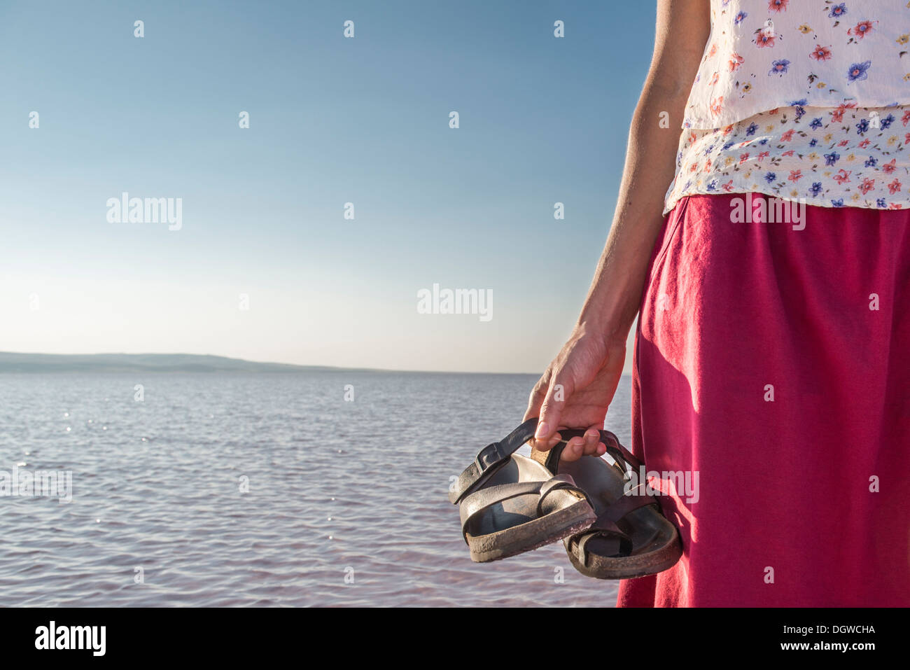 Woman Standing in salt lake with shoes off Stock Photo