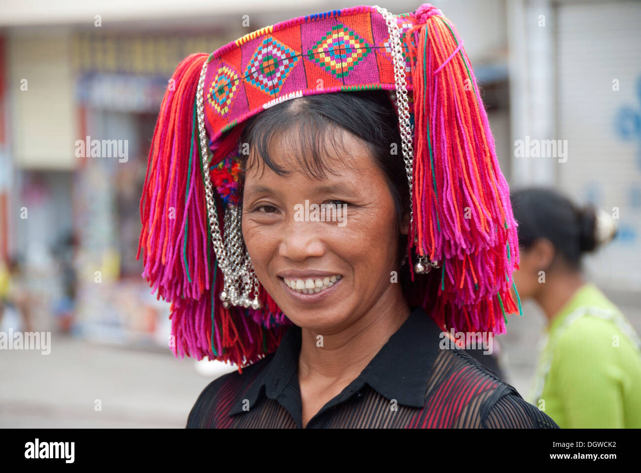Woman of the Yi or Hani ethnic minority wearing colourful headware at a festival, Jiangcheng, Pu'er City, Yunnan Province Stock Photo
