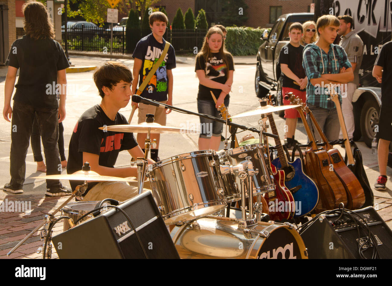 Young drummer rock musicians playing at an outdoor performance