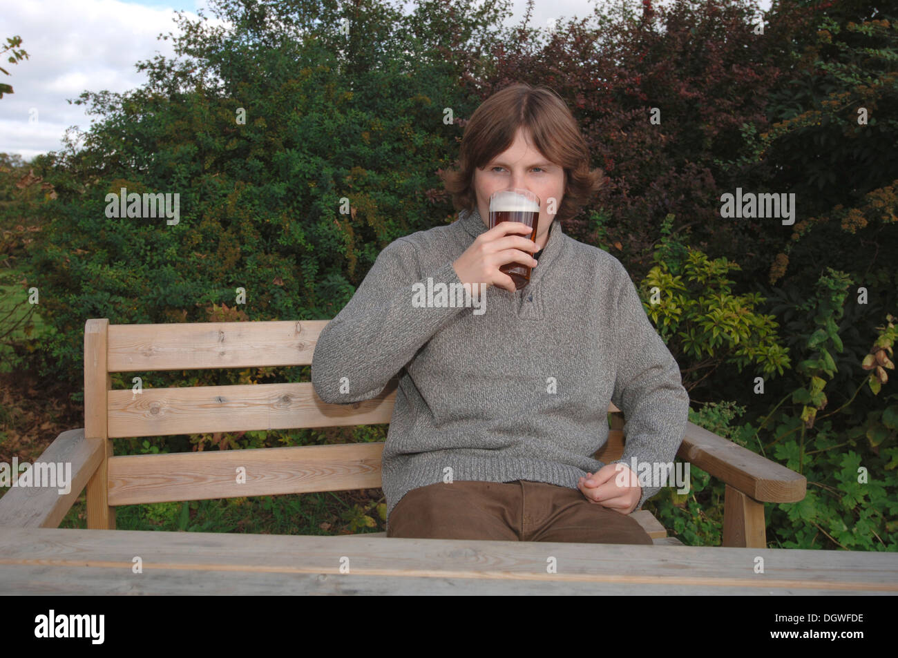 A Male 18yr Old Teenager Drinking A Pint Of Beer. Stock Photo