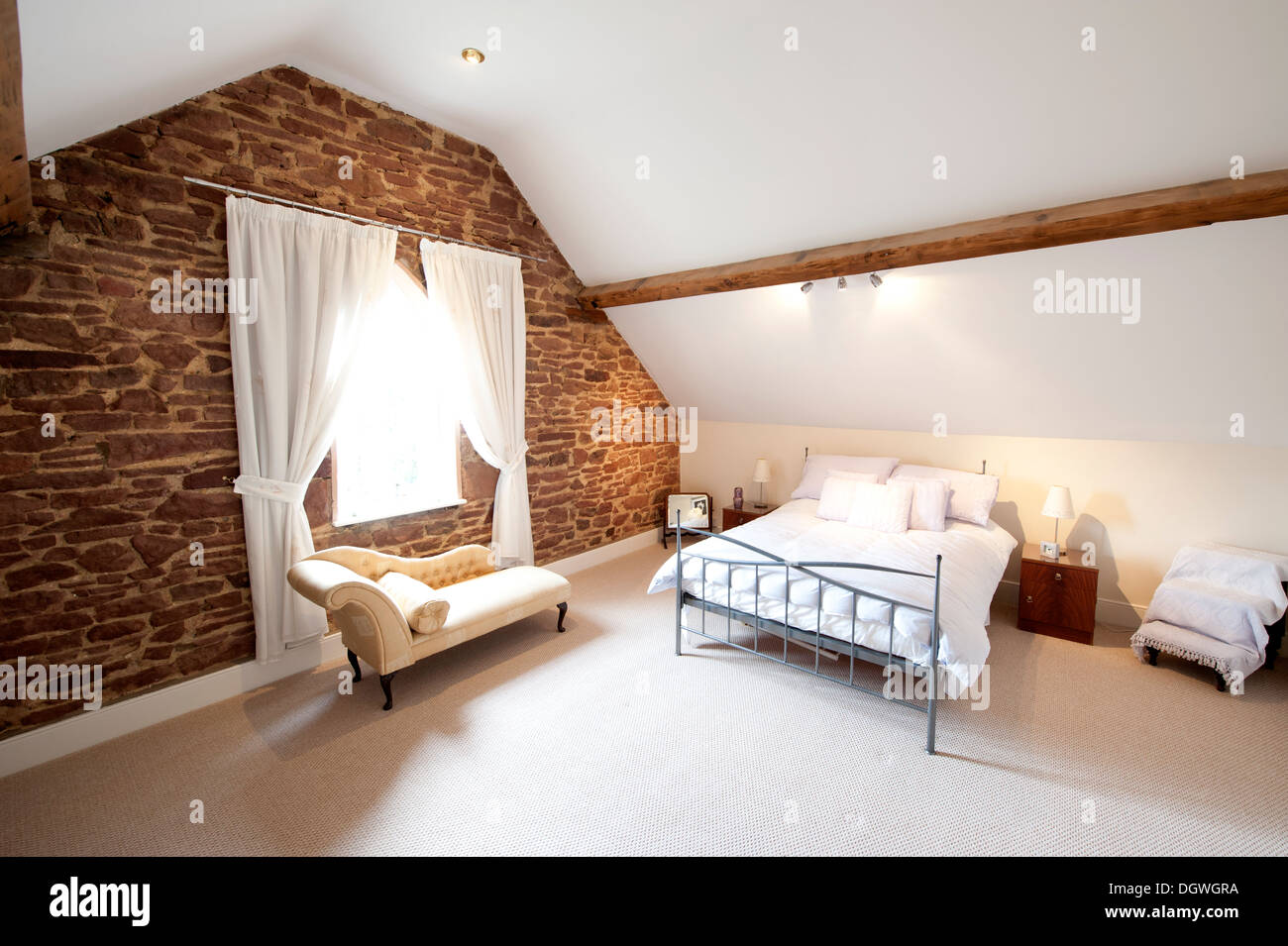 Old sandstone cottage attic bedroom white modern big Stock Photo
