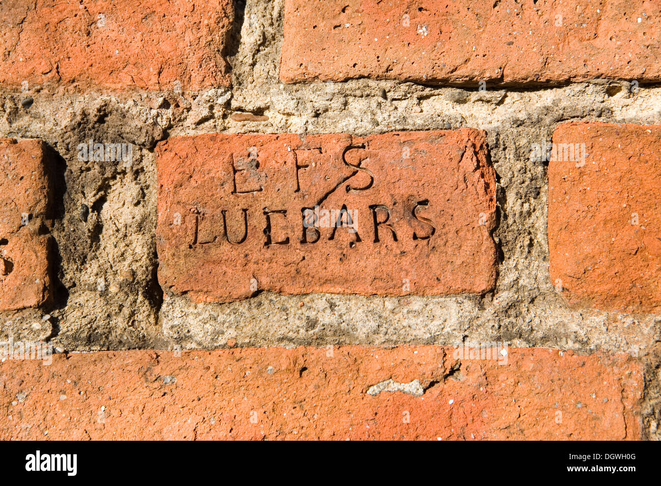 Old brick in a wall with the seal of EFS Luebars brickyard, founded in 1854 by Spandau brickyard owner E.F. Schulz Stock Photo