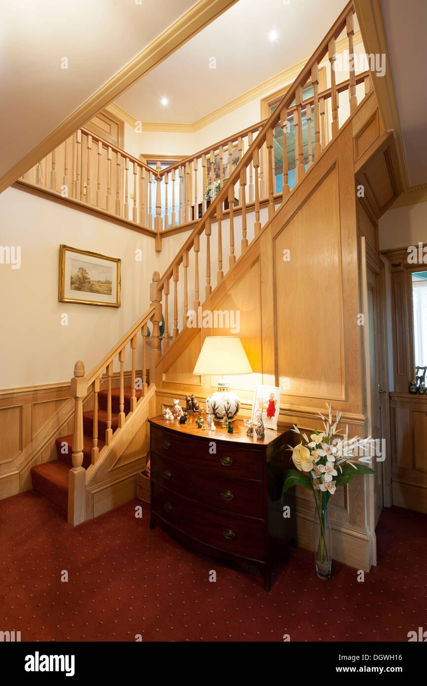 Large entrance hall and staircase house warm welcoming Stock Photo