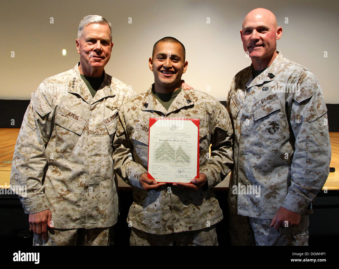 The 35th commandant of the Marine Corps, General James F. Amos, and the 17th sergeant major of the Marine Corps, Sgt. Maj. Micheal P. Barrett, promote Cpl. Miguel Ocampo, avionics technician with Marine Aviation Logistics Squadron 16 (MALS-16), Marine Air Stock Photo