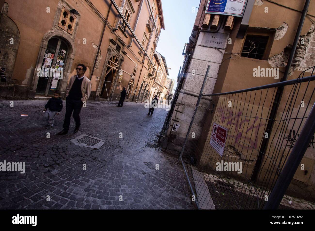 Oct. 26, 2013 - L'Aquila, Italy - People walk on October 25, 2013 in the historic area of LÌ¢??Aquila, destroyed by an earthquake four years ago, on April 6, 2009. Four years after, the historic center is still abandoned, the reconstruction process is slow outside of commercial premises and the city's churches and monuments are still covered in scaffolding.Photo: Manuel Romano/NurPhoto (Credit Image: © Manuel Romano/NurPhoto/ZUMAPRESS.com) Stock Photo