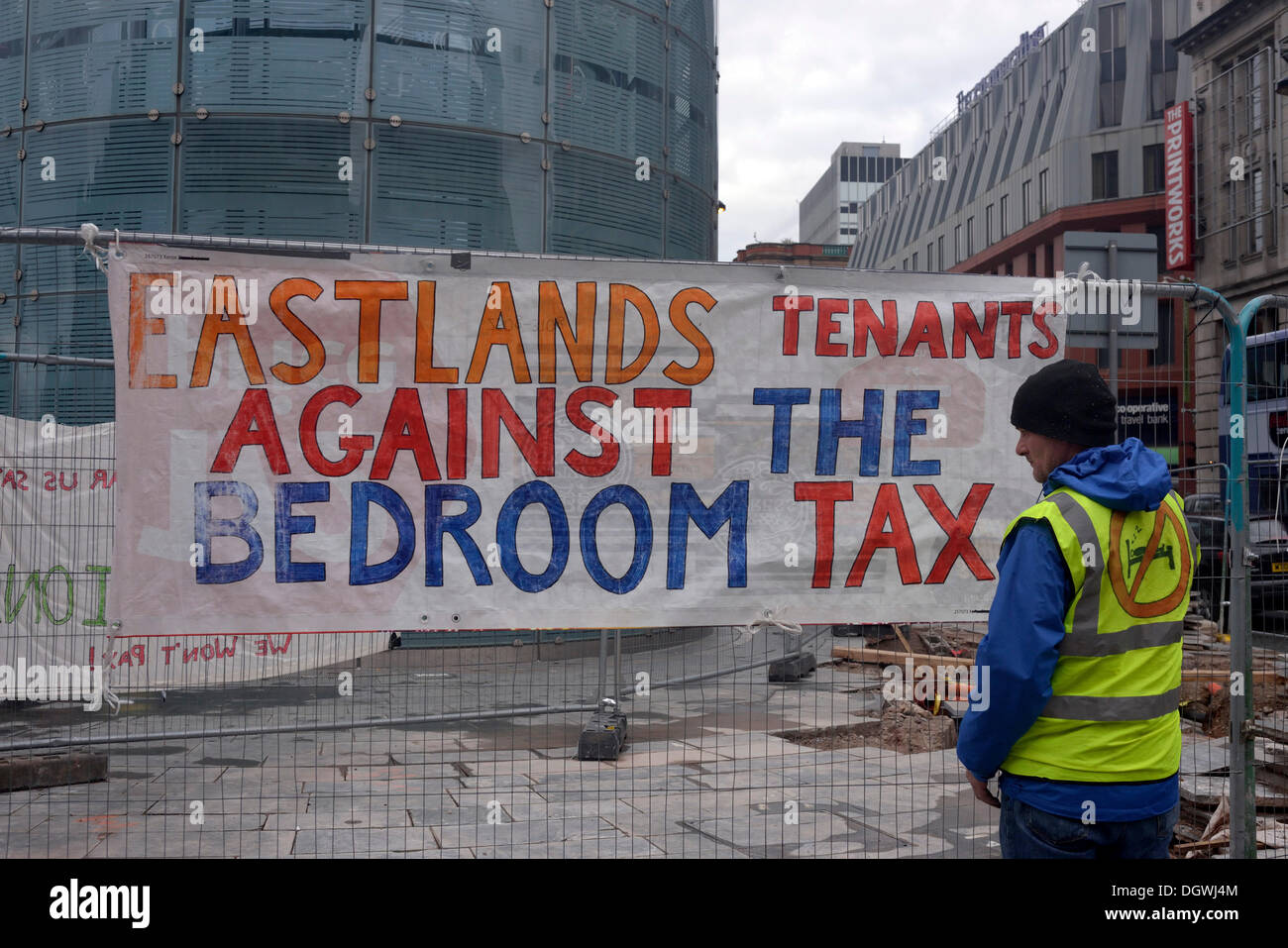 Manchester, UK. 26th Oct, 2013. A protester looks at a banner showing the displeasure of a small anti-Coalition Government group protesting against the bedroom tax and government measures, which are making the life of the ordinary citizen worse than before.  Credit:  John Fryer/Alamy Live News Stock Photo