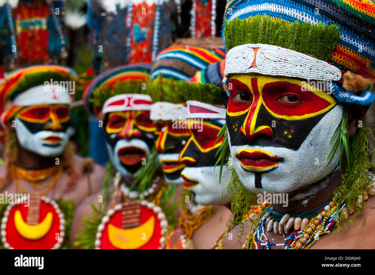 Men in colourfully decorated costumes with face paint celebrating at ...
