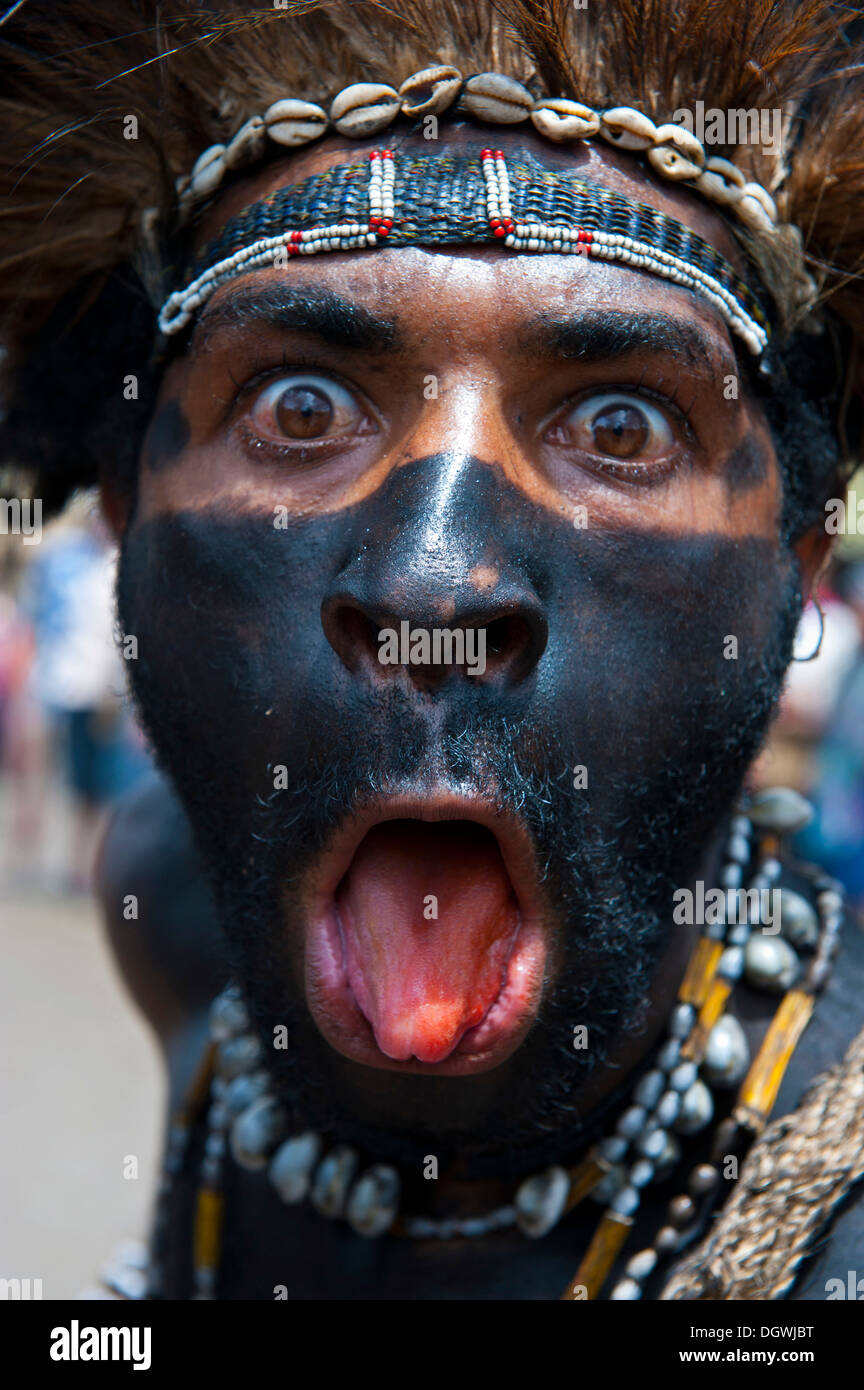 Black painted and decorated man during the traditional Sing Sing in the highlands, Enga, Highlands, Papua New Guinea Stock Photo