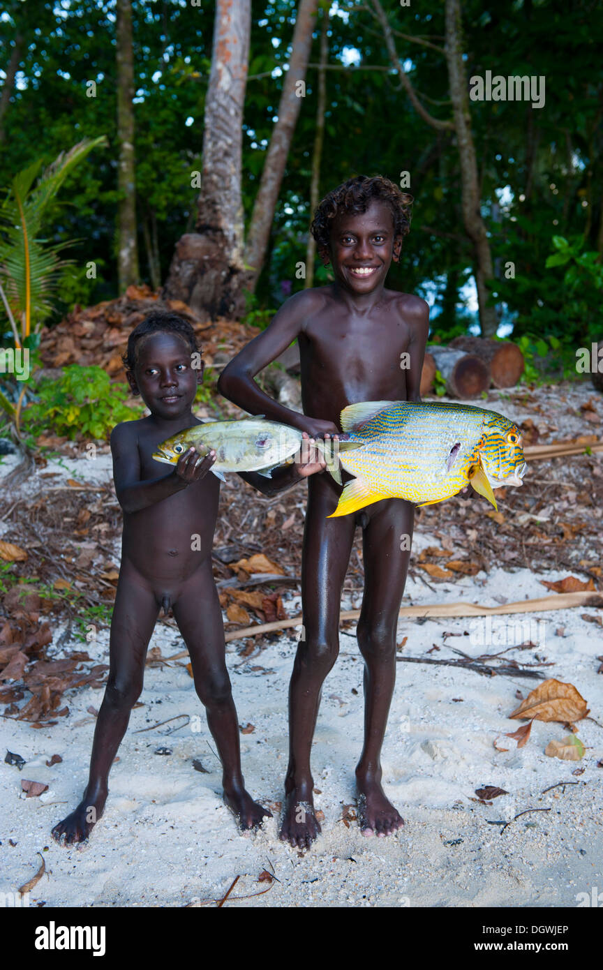 Boys proudly showing the fish they caught, Marovo Lagoon, Western Province, Solomon Islands Stock Photo