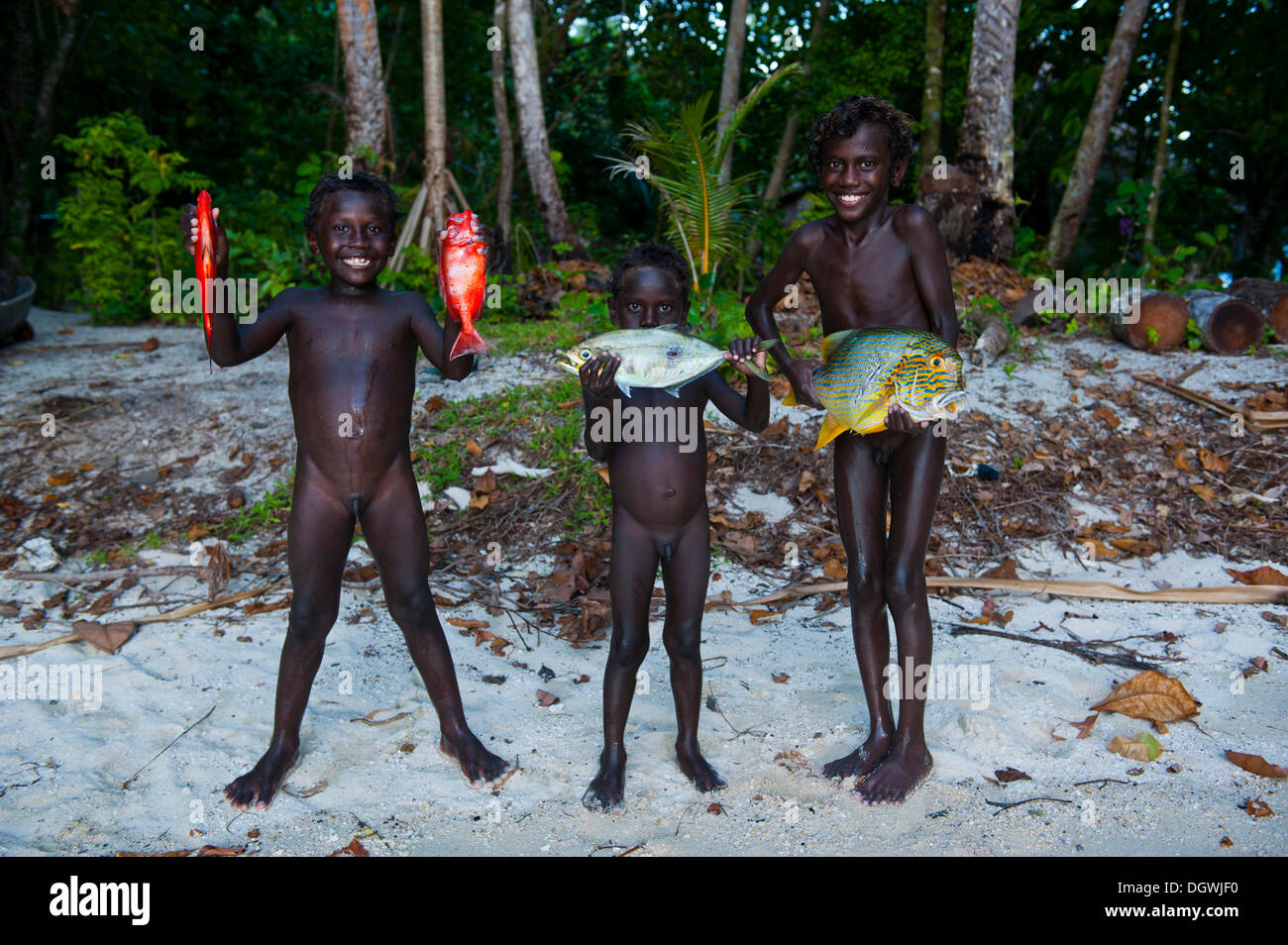 Boys proudly showing the fish they caught, Marovo Lagoon, Western Province, Solomon Islands Stock Photo