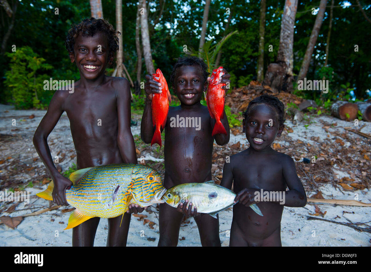 Boys proudly showing the fish they caught, Marovo Lagoon, Western Province, Solomon Islands Stock Photo