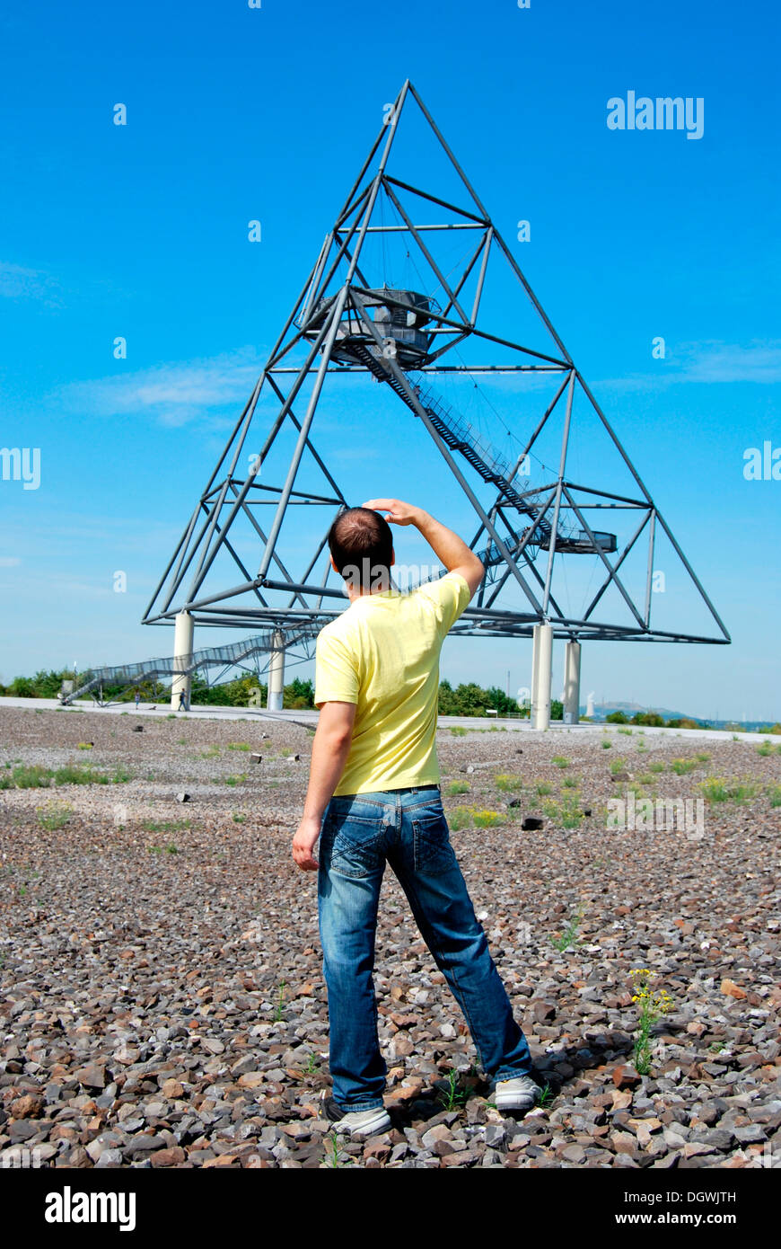Young man standing in front of the Tetraeder landmark, a tetrahedron made from steel, industrial heritage Stock Photo