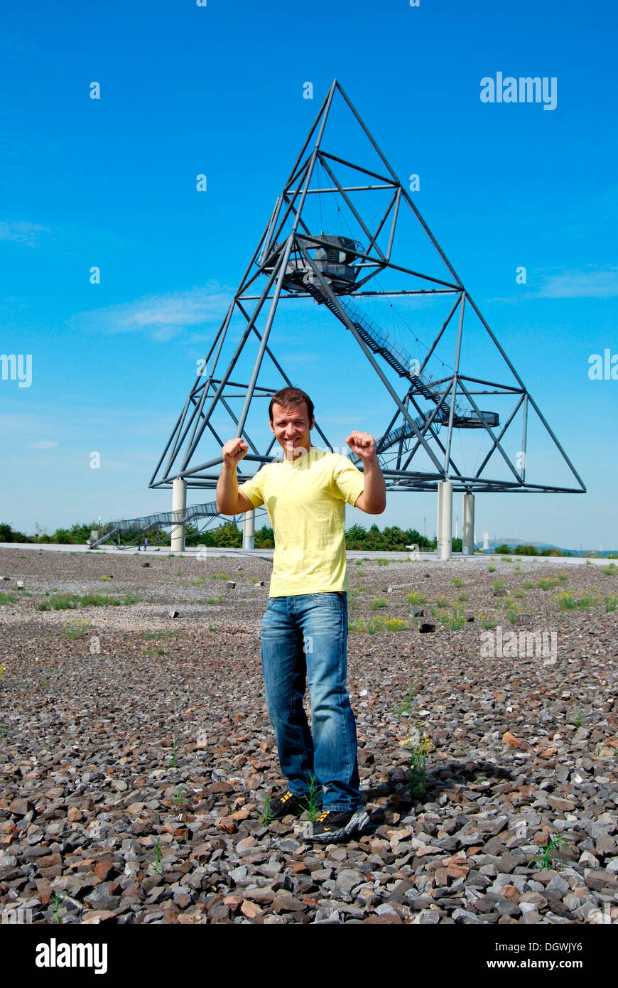 Young man standing in front of the Tetraeder landmark, a tetrahedron made from steel, industrial heritage Stock Photo