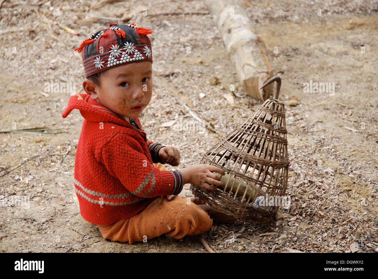 small red dao tribe boy playing with homemade basket Stock Photo