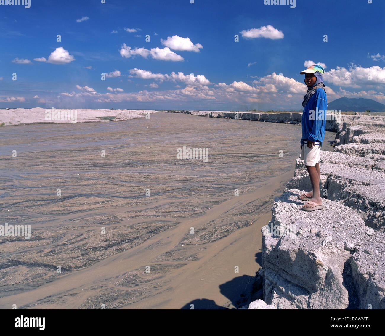 Boy standing on the bank of a mudstream, Mt Pinatubo, lahar fields, lahar, pyroclastic flow, Zambales, Pampanga, Luzon Stock Photo