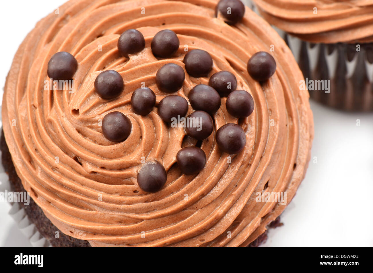 Gourmet chocolate cupcakes with chocolate chiffon icing and chocolate balls from an overhead position Stock Photo