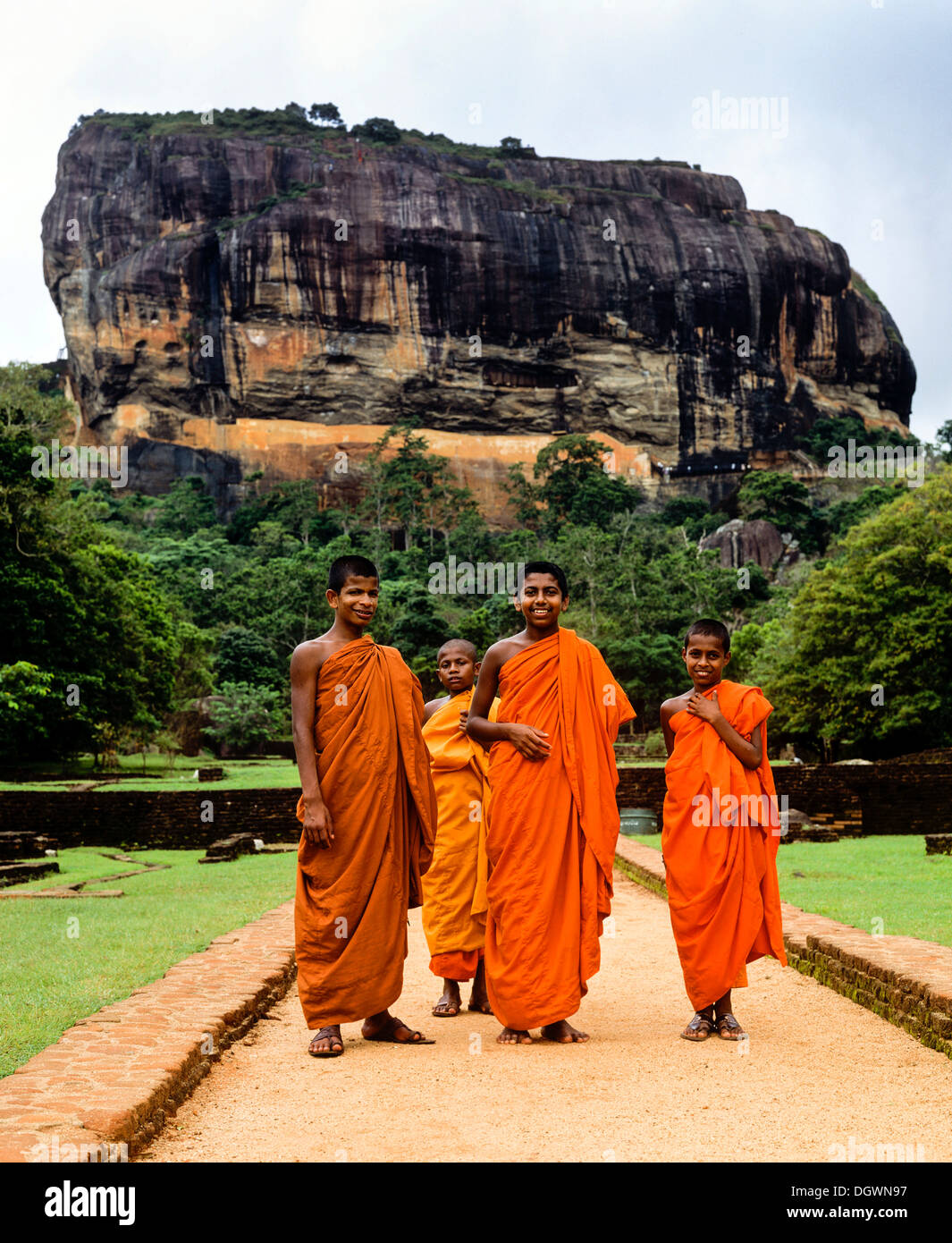 Monks standing in front of the Rock of Sigiriya, Lion Rock, column of ...