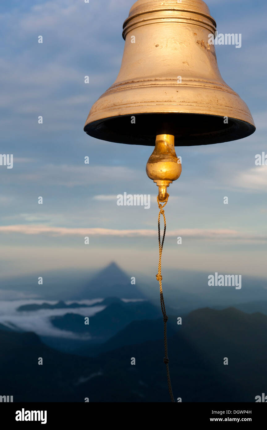 Bell, the shadow of the mountain at the back, the image of God, holy mountain, buddhist temple, Adam's Peak, Sri Pada, Dalhousie Stock Photo
