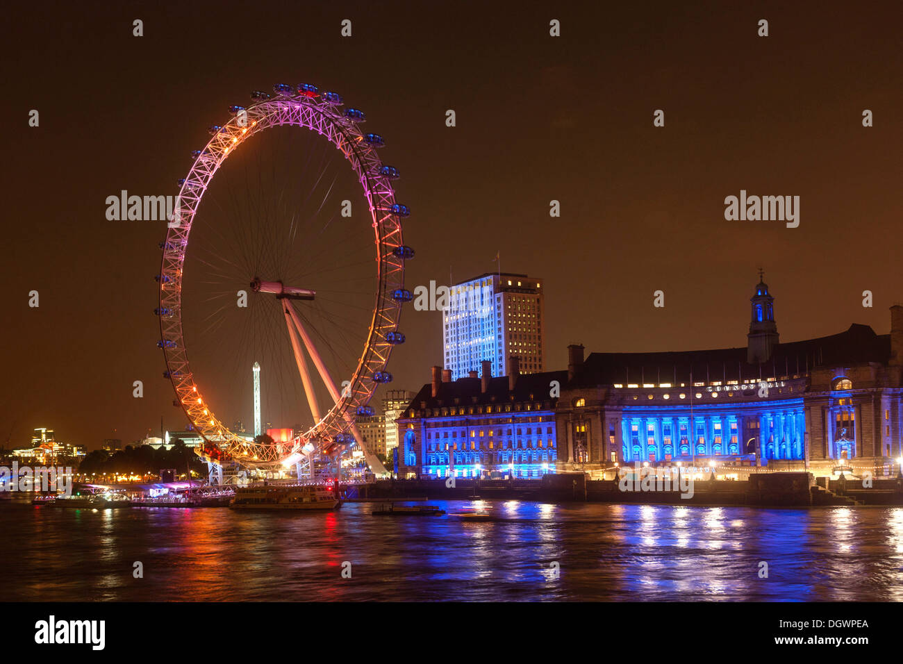 Night shot, The London Eye in orange light, County Hall in blue light, River Thames, London, England, United Kingdom, Europe Stock Photo