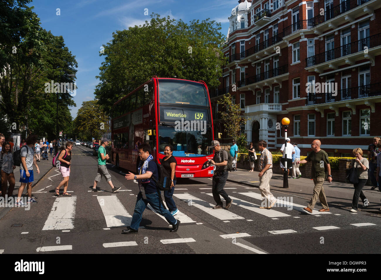 Tourists on the zebra crossing of the famous Beatles album cover, Abbey Road, London, England, United Kingdom, Europe Stock Photo