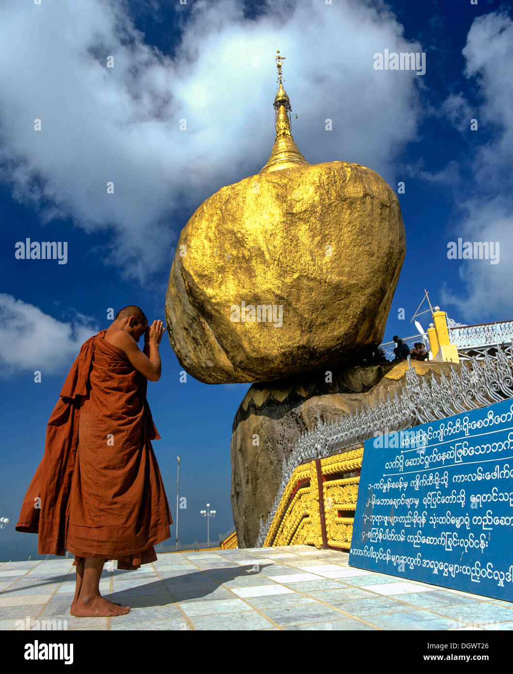 Buddhist Monk Praying In Front Of The Golden Rock Or Kyaiktiyo Stock Photo Alamy