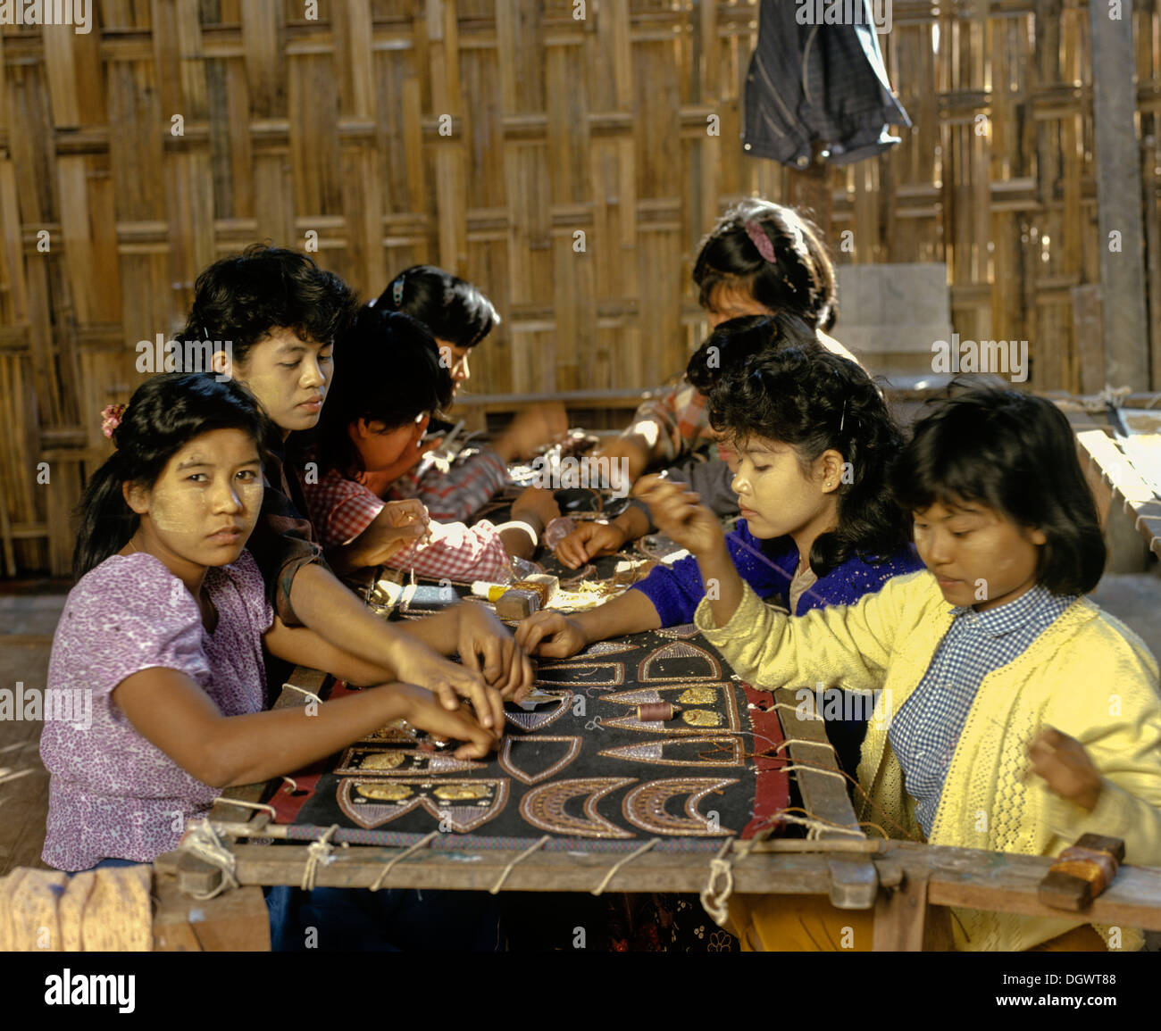 Child labour, young girls with thanaka paste on their faces at work, Mandalay, Mandalay Division, Myanmar, Burma Stock Photo