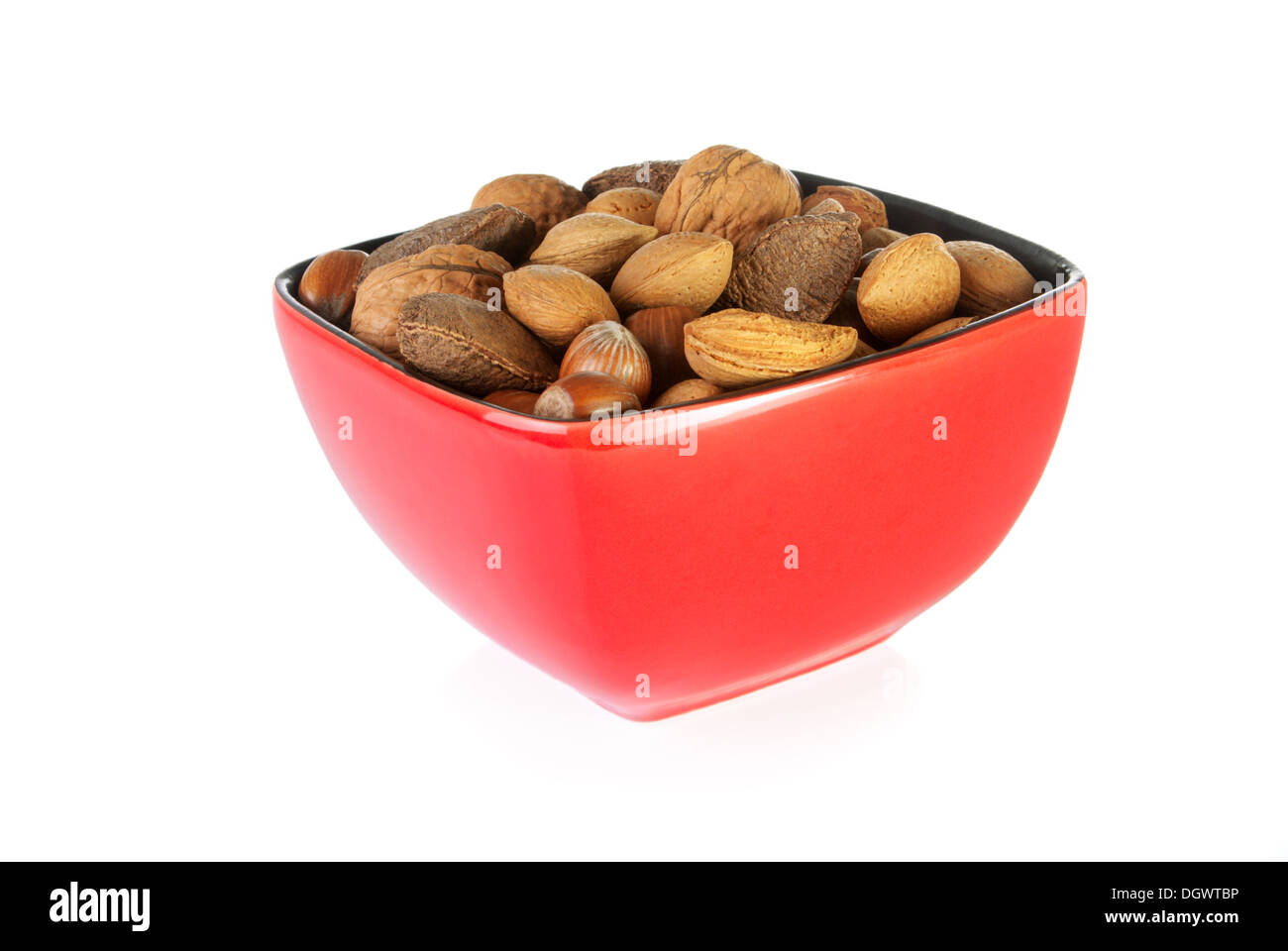 Bowl of mixed nuts containing almonds, hazelnuts, walnuts and Brazil nuts on a white background Stock Photo