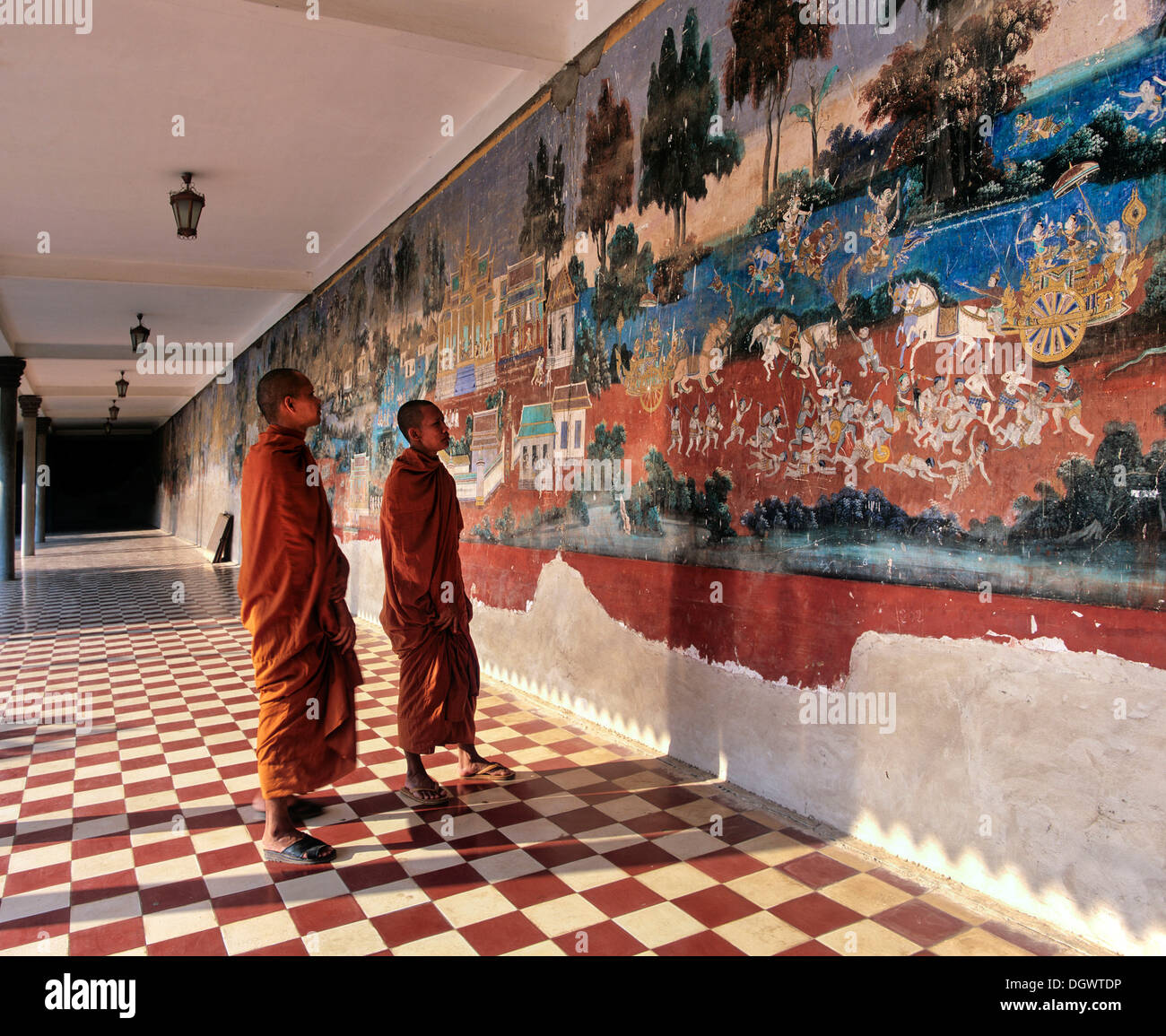 Monks standing in front of a wall painting from the Ramayana epic in the Silver Pagoda or Preah Vihear Preah Keo Morakot Stock Photo