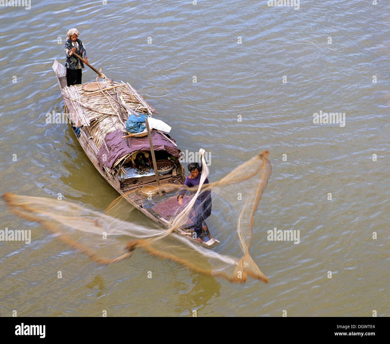 Fisherman casting his net, fishing boat on the Tonle Sap River, Phnom Penh, Phnom Penh Province, Cambodia Stock Photo