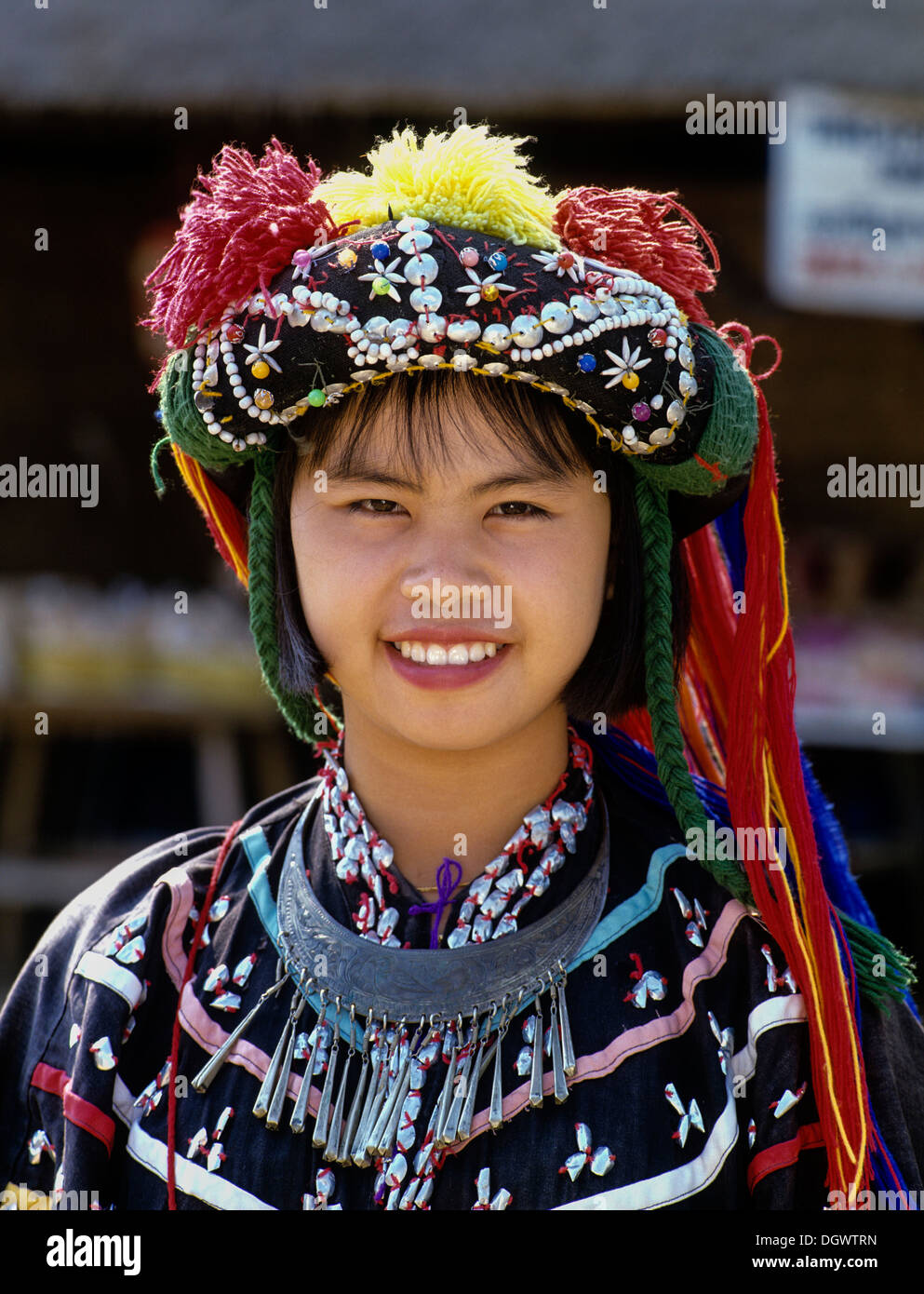 Lisu girl wearing a colourful headdress and the traditional costume of