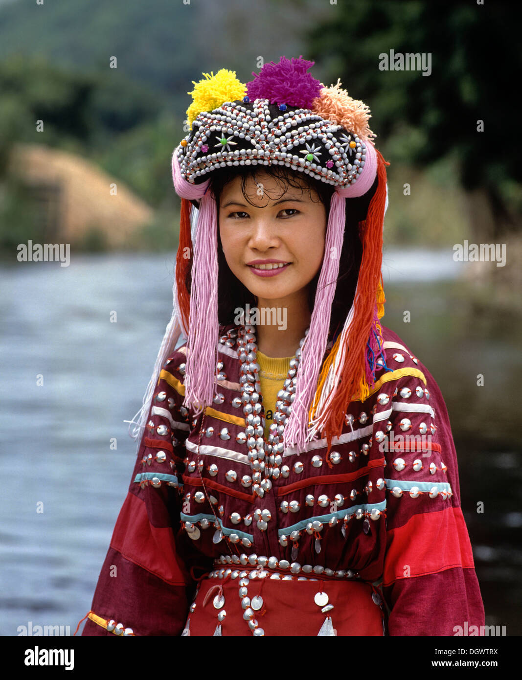 Lisu girl wearing a colourful headdress and the traditional costume of