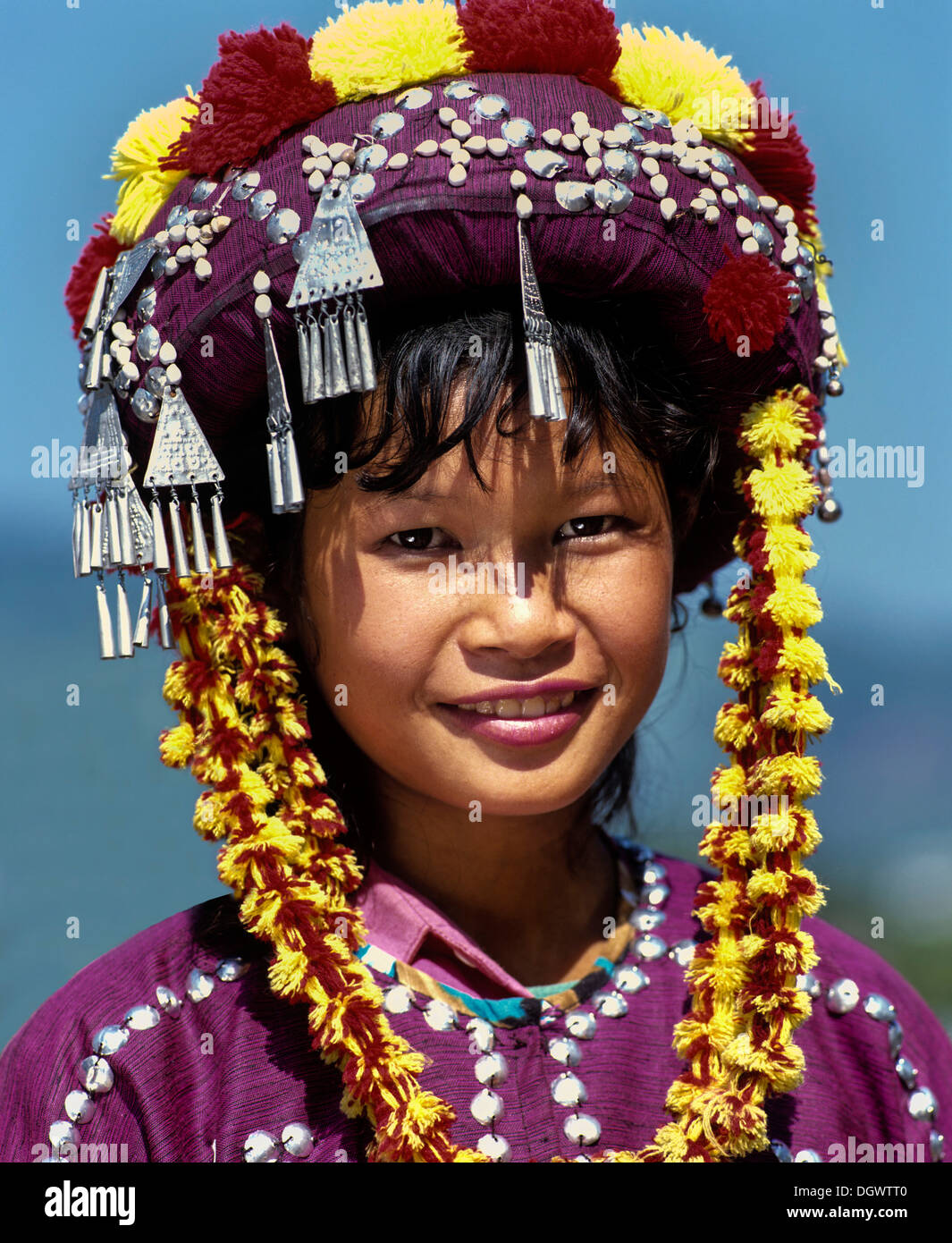 Lisu girl wearing a colourful headdress and the traditional costume of