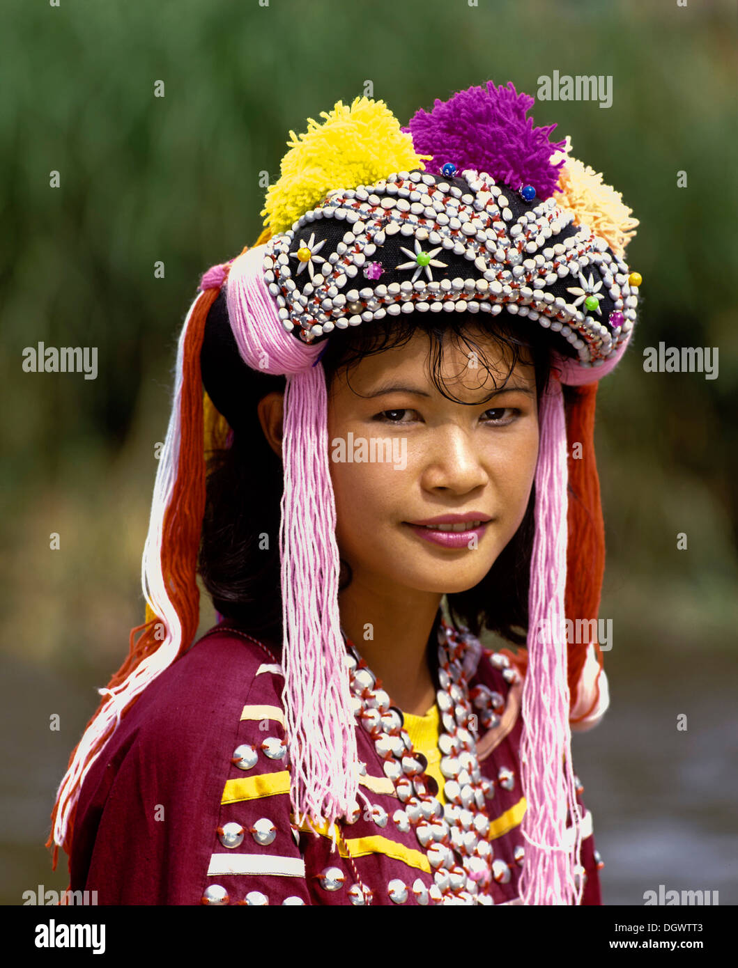 Lisu girl wearing a colourful headdress and the traditional costume of