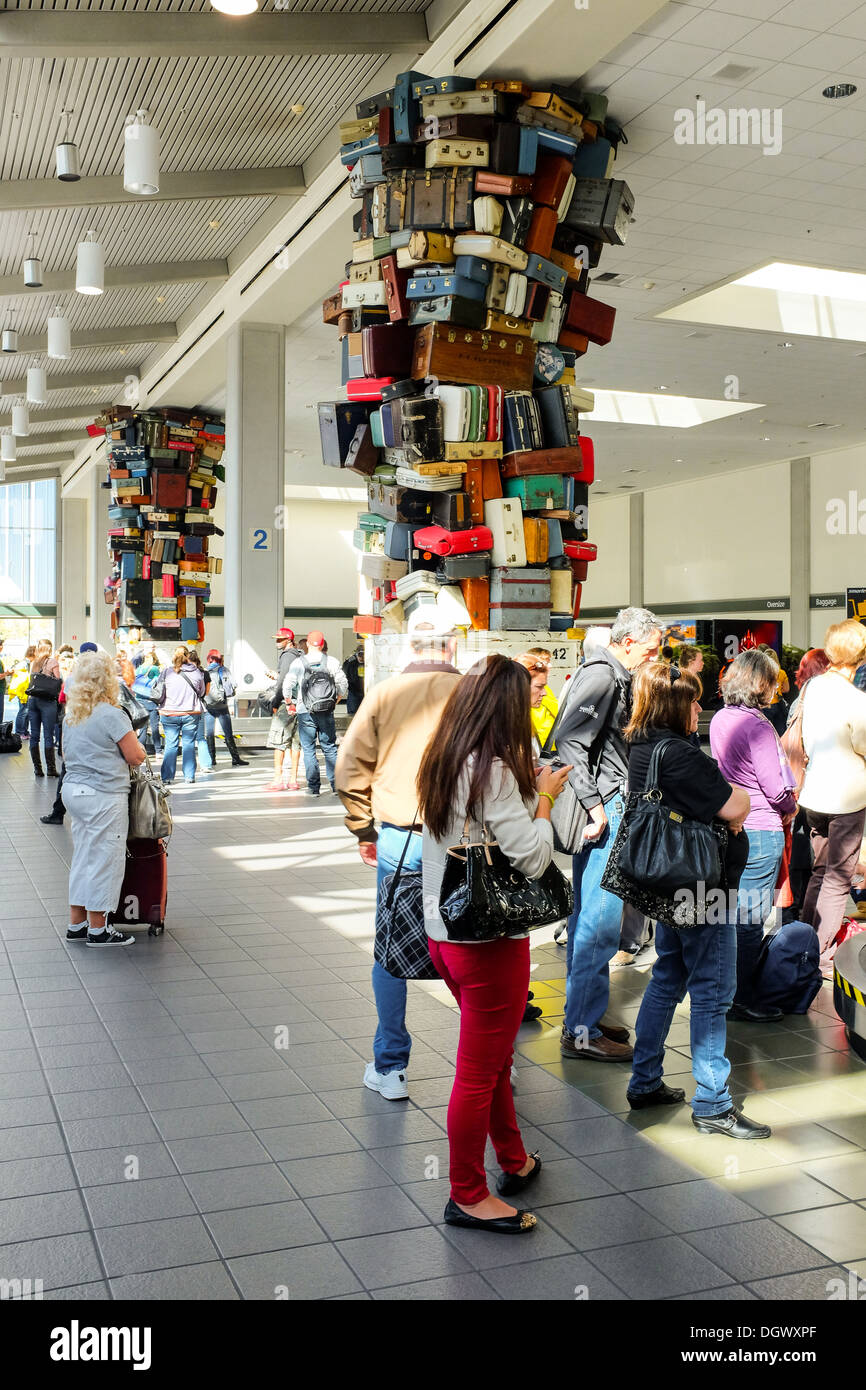 Travelers await the arrival of their baggage at the Sacramento Airport in California Stock Photo