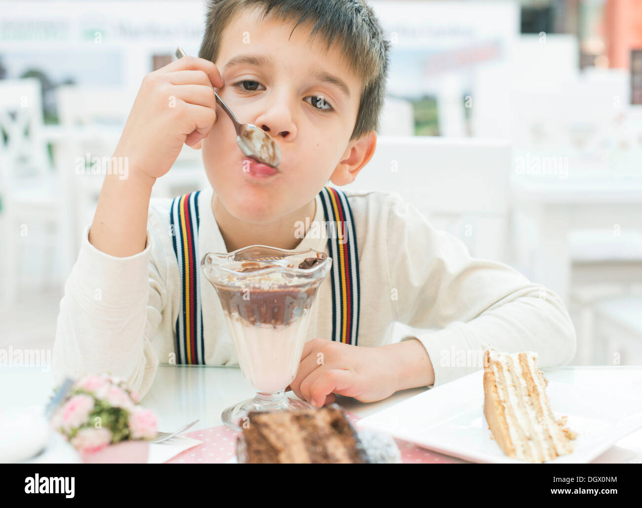 Child eat milk choco shake on a table Stock Photo