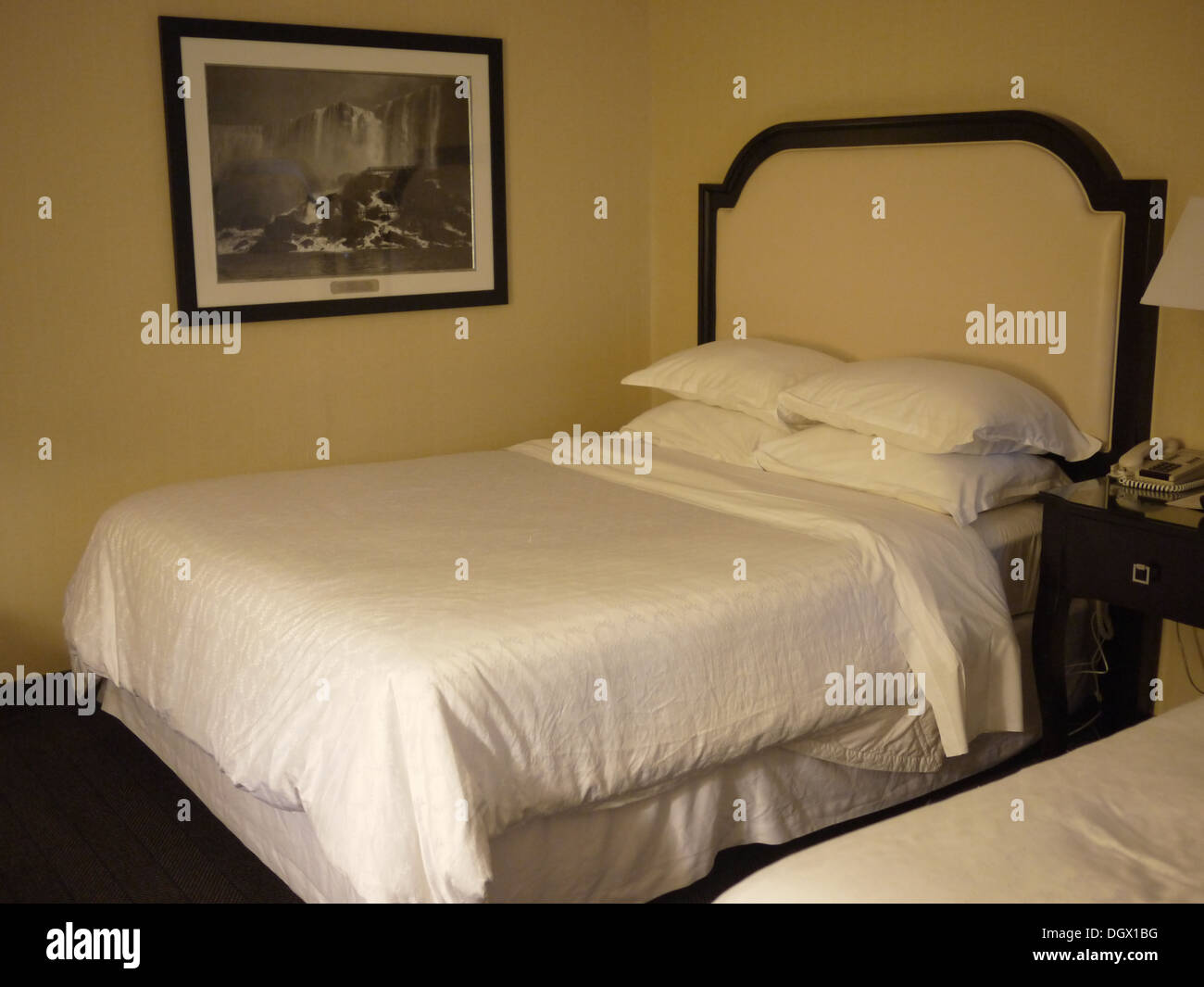 queen size sheraton hotel bed Stock Photo