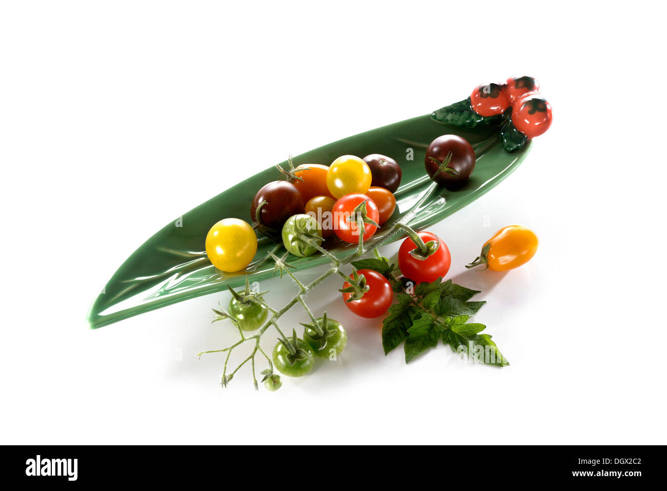 Wild tomatoes in an elongated leaf-shaped bowl Stock Photo